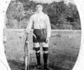 Young man in shorts with a bicycle